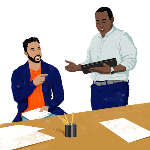 Two people discussing paperwork.
