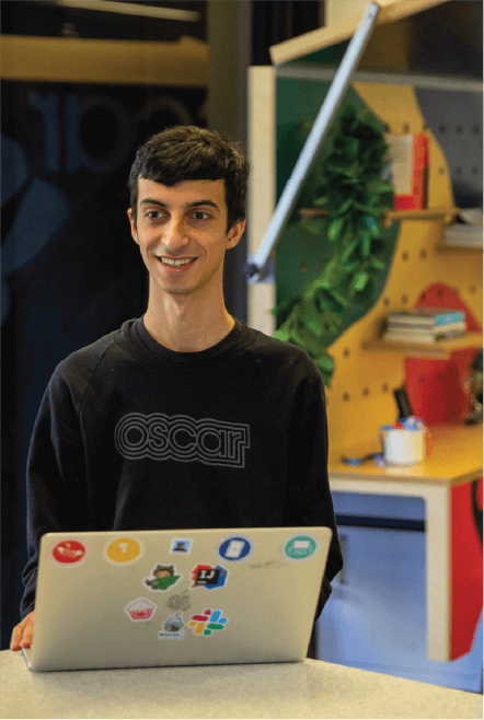 Smiling man in front of a computer
